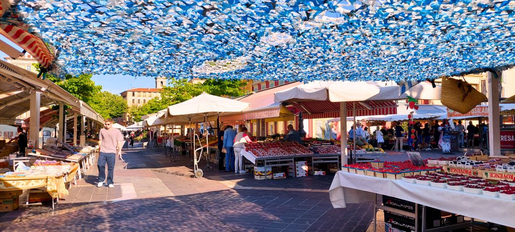 Bunter Blumen- und Obstmarkt am Cours Saleya in Nizza mit Marktständen, Sonnenschirmen und mediterranem Flair