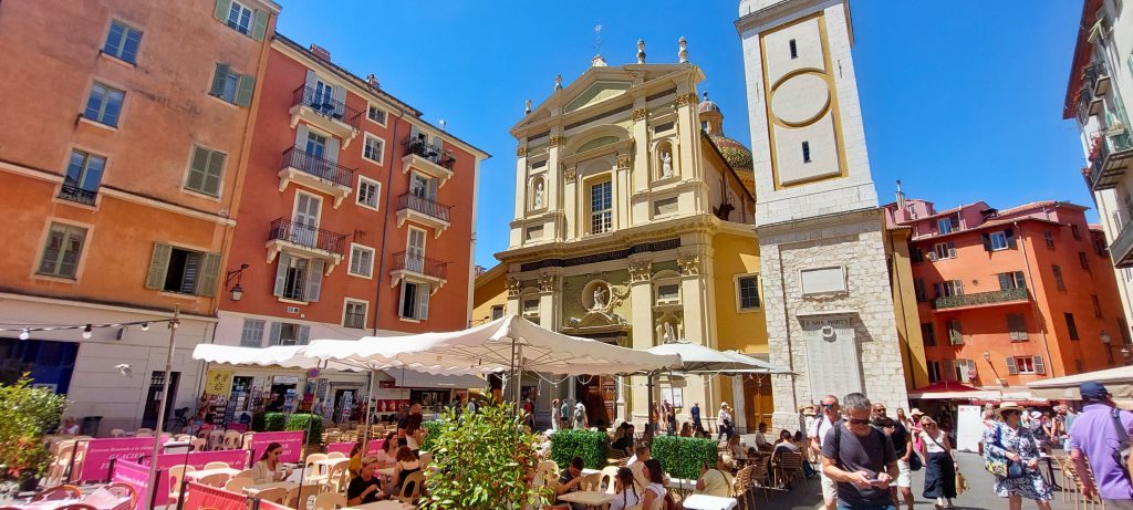 Kathedrale Sainte-Réparate in der Altstadt von Nizza mit barocker Fassade und belebtem Platz voller Cafés und Menschen